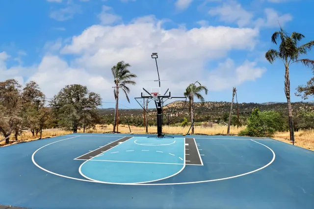 a kitchen with granite countertop a sink stove and cabinets