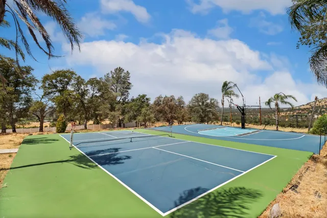 a view of a white house with a yard