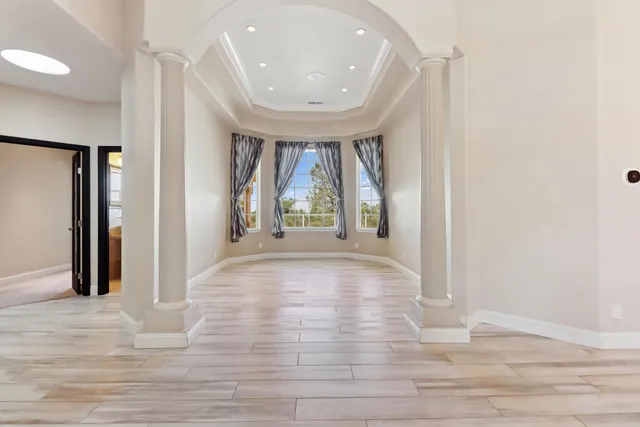 a view of a livingroom with wooden floor and white wall