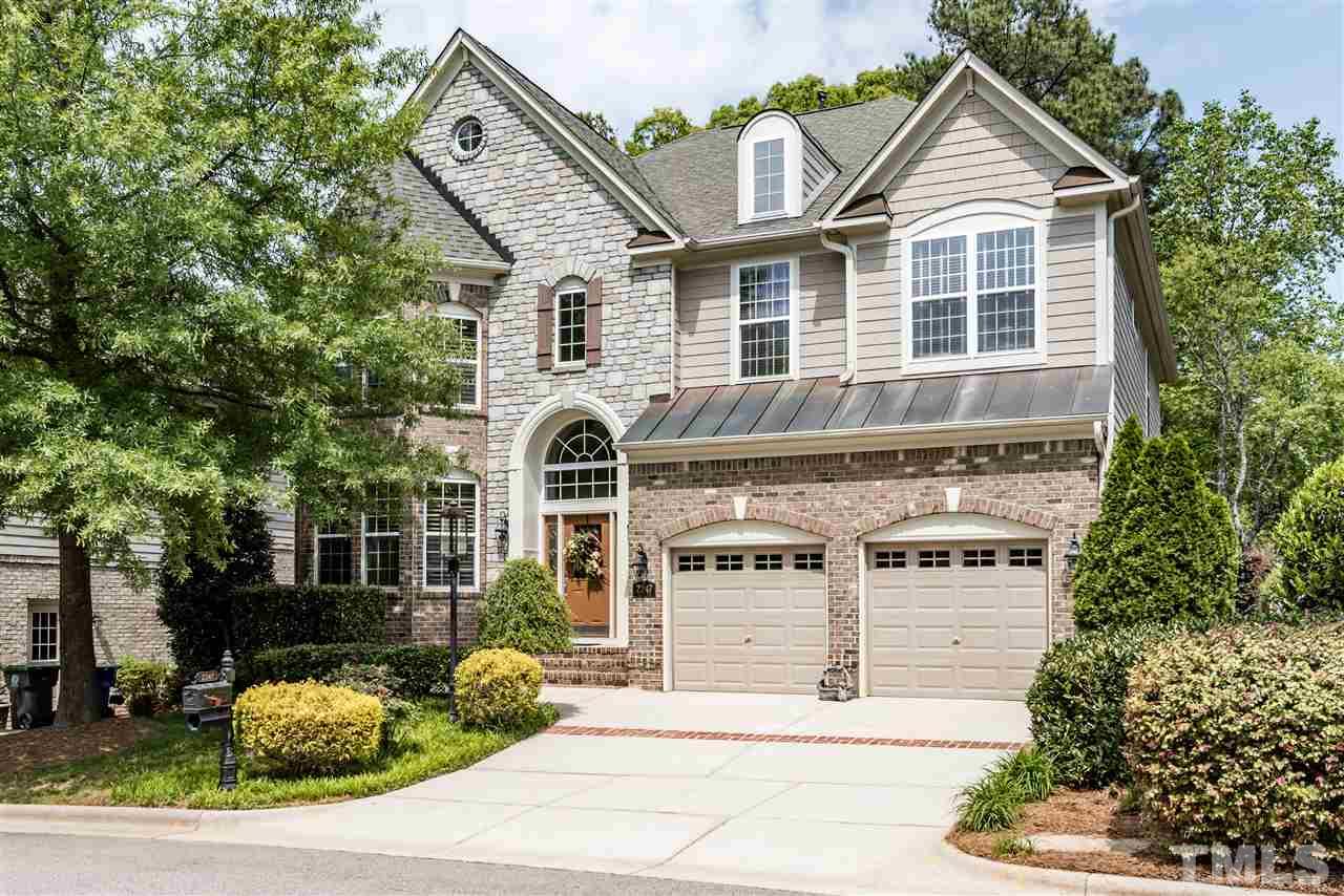 2247 Clayette Court Raleigh, NC 27612 - Photo 1 of 25 a view of a white house with large windows and a yard with plants and large tree
