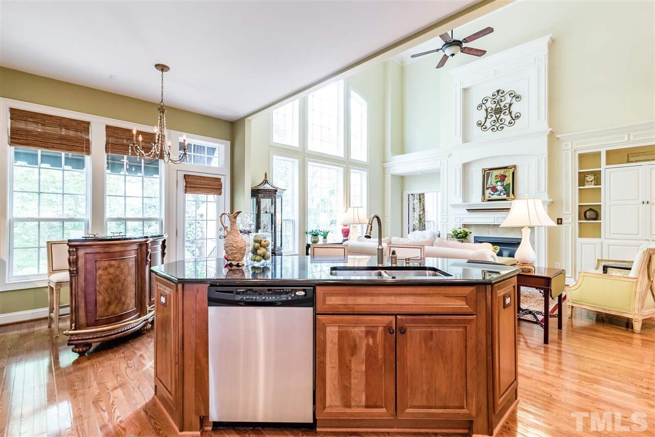 2247 Clayette Court Raleigh, NC 27612 - Photo 13 of 25 a dining hall with stainless steel appliances granite countertop a stove and a sink with wooden floor