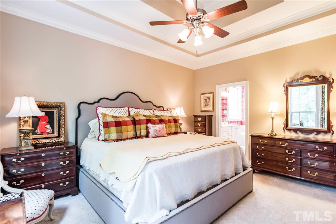 2247 Clayette Court Raleigh, NC 27612 - Photo 16 of 25 a bedroom with a bed and a chandelier