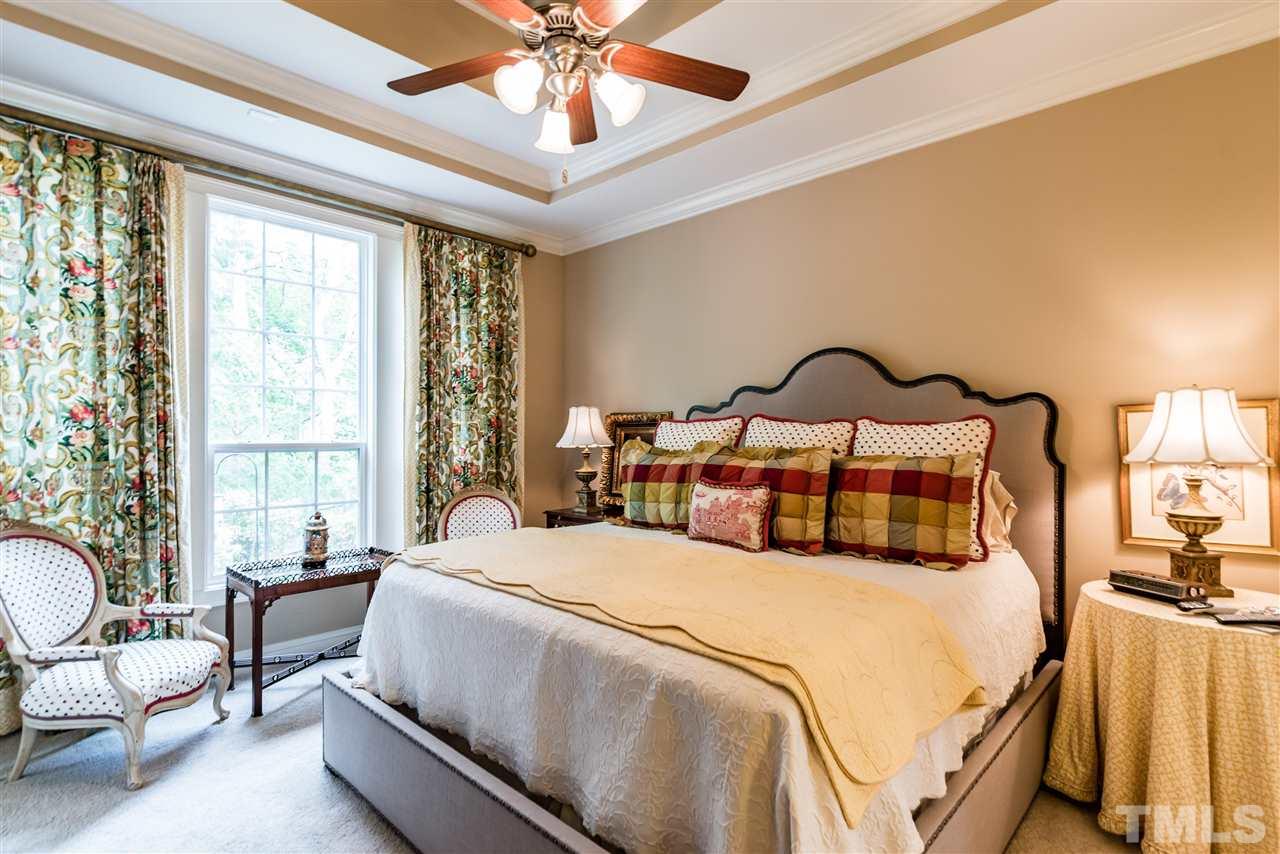 2247 Clayette Court Raleigh, NC 27612 - Photo 17 of 25 a bedroom with a bed and a chandelier