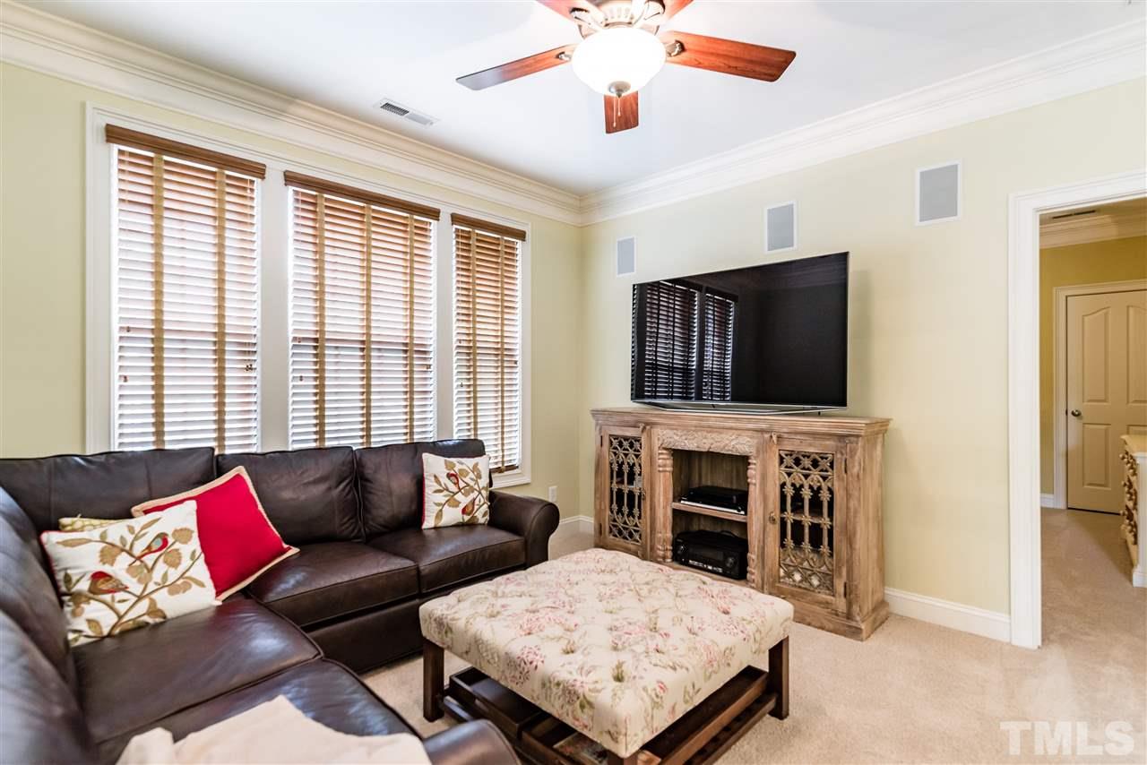 2247 Clayette Court Raleigh, NC 27612 - Photo 19 of 25 a living room with furniture flat screen tv and a fireplace