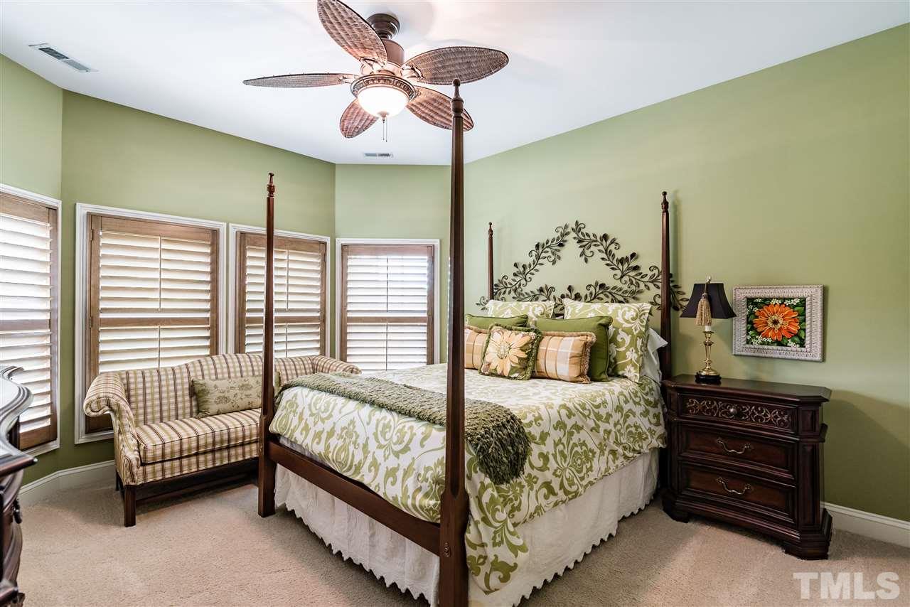 2247 Clayette Court Raleigh, NC 27612 - Photo 21 of 25 a bedroom with a bed and a chandelier