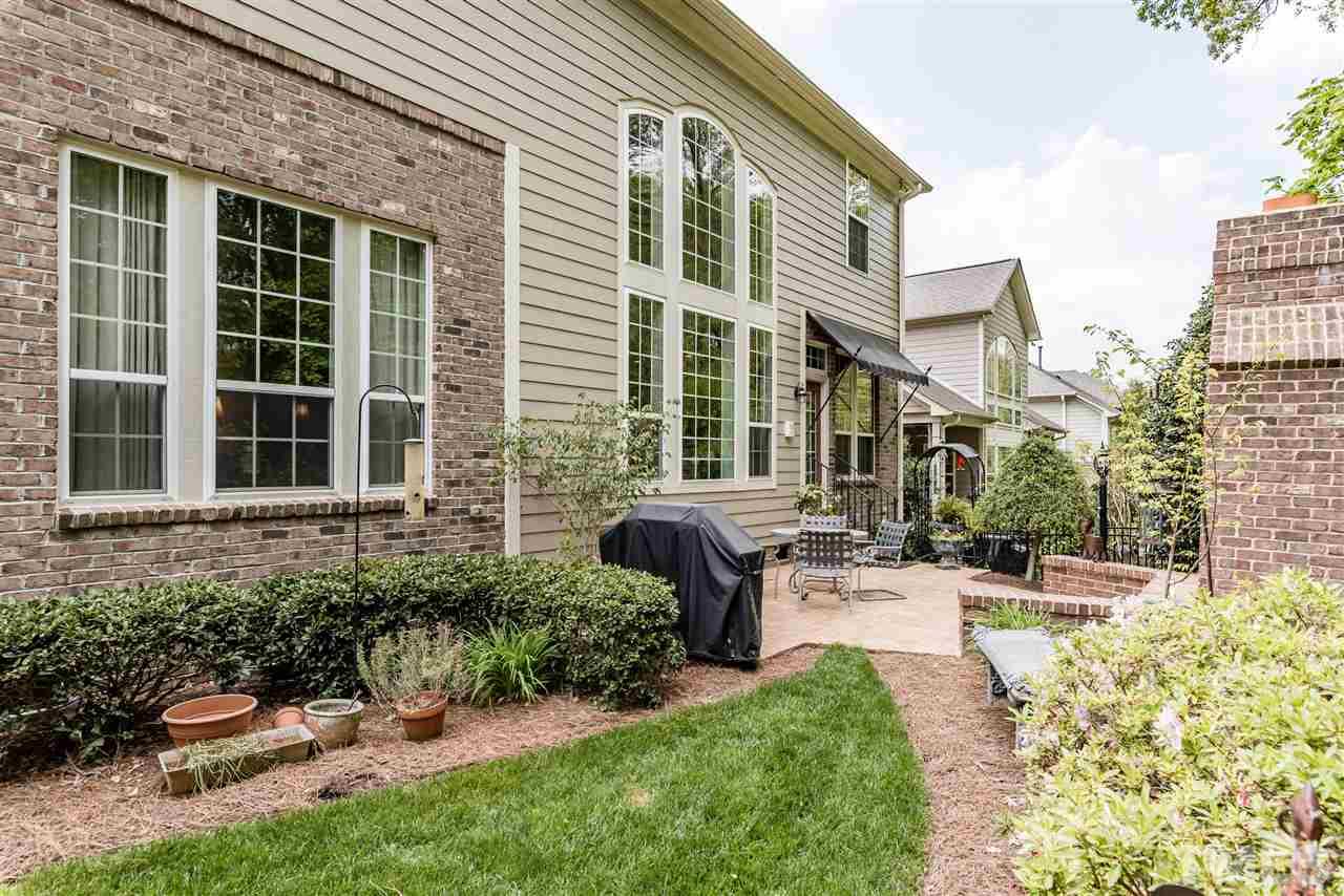 2247 Clayette Court Raleigh, NC 27612 - Photo 23 of 25 a view of a patio with table and chairs and potted plants