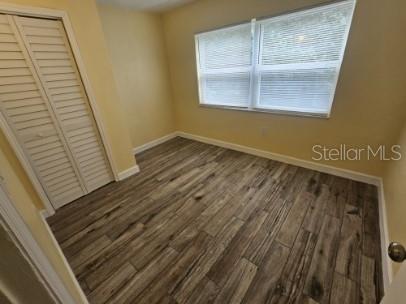 2035 Alpine Road, Unit 6 Clearwater, FL 33755 - Photo 14 of 17 a view of an empty room with wooden floor and a window