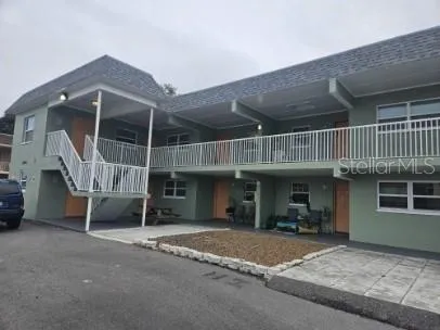 a view of a house with a patio and a yard