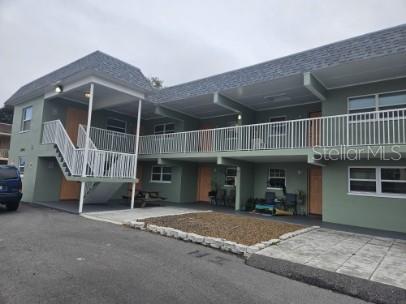 2035 Alpine Road, Unit 6 Clearwater, FL 33755 - Photo 3 of 17 a view of a house with a patio and a yard