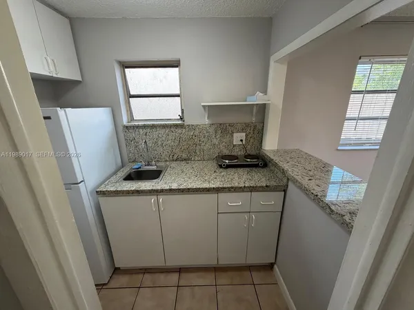 a kitchen with sink cabinets and window