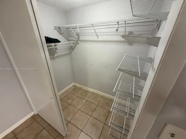 a view of storage and utility room with racks on the wall