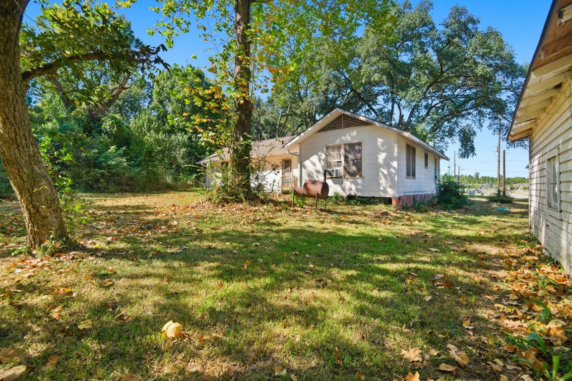1200 Foster Drive Conroe, TX 77301 - Photo 13 of 18 a front view of a house with a yard