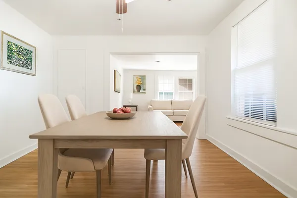 a view of a dining room with furniture and wooden floor