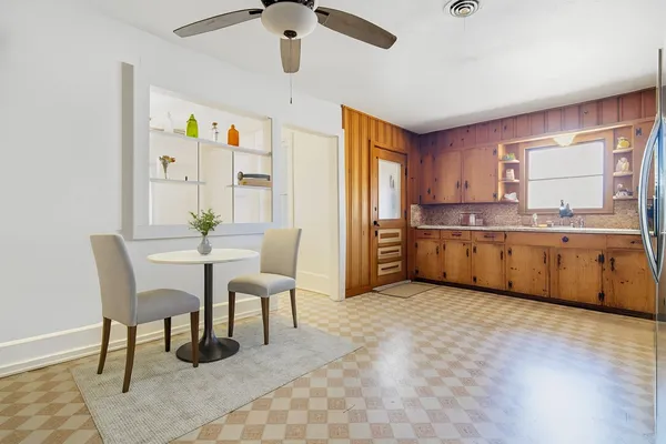 a view of a kitchen with a dining table chairs and entryway
