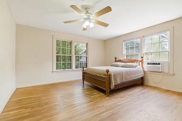 a bedroom with a bed and window