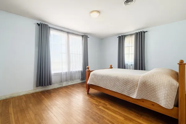 a bedroom with a bed and window