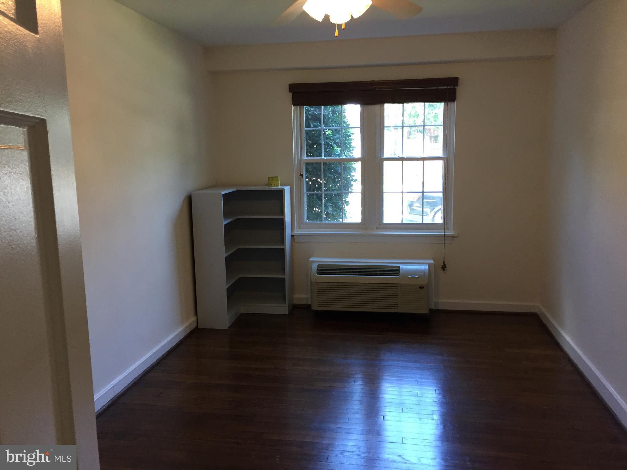 111 East Glebe Road, Unit D Alexandria, VA 22305 - Photo 8 of 14 an empty room with wooden floor and windows