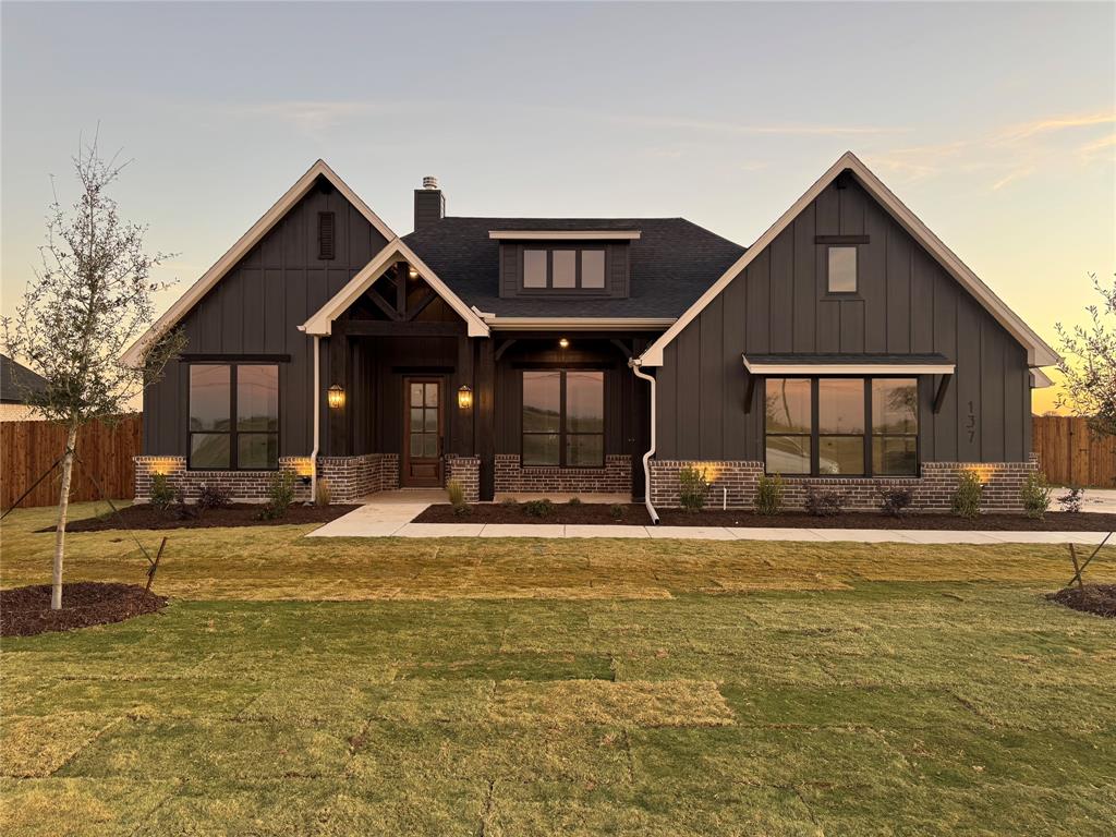 a front view of a house with a yard table and chairs