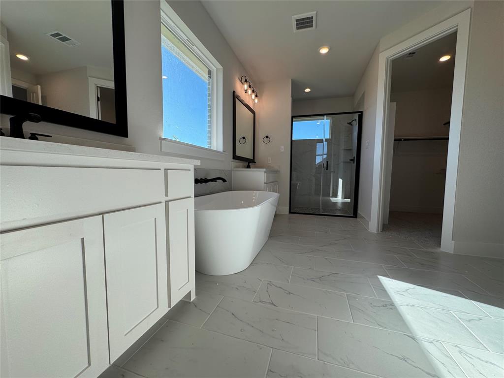 137 Red Fox Trail Godley, TX 76044 - Photo 11 of 18 a bathroom with a bathtub and shower