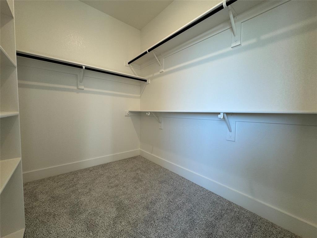 137 Red Fox Trail Godley, TX 76044 - Photo 13 of 18 a view of a room with racks on the wall