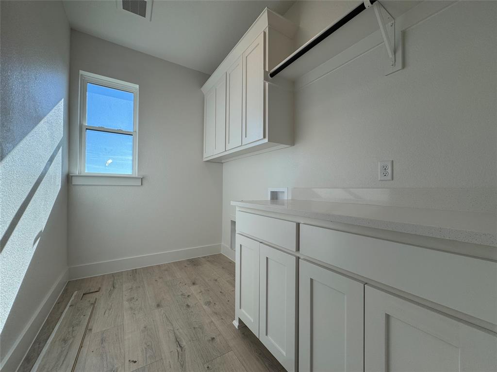 137 Red Fox Trail Godley, TX 76044 - Photo 15 of 18 a view of cabinets with wooden floor