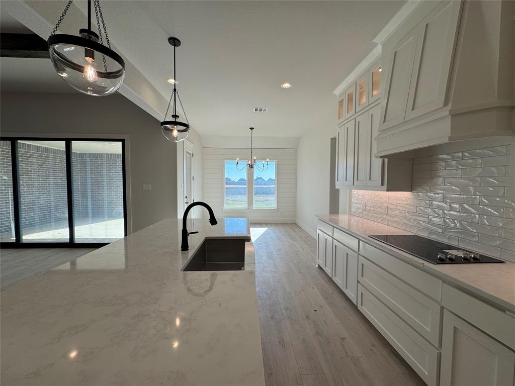 137 Red Fox Trail Godley, TX 76044 - Photo 3 of 18 a kitchen with stainless steel appliances granite countertop a lot of counter space and wooden floors