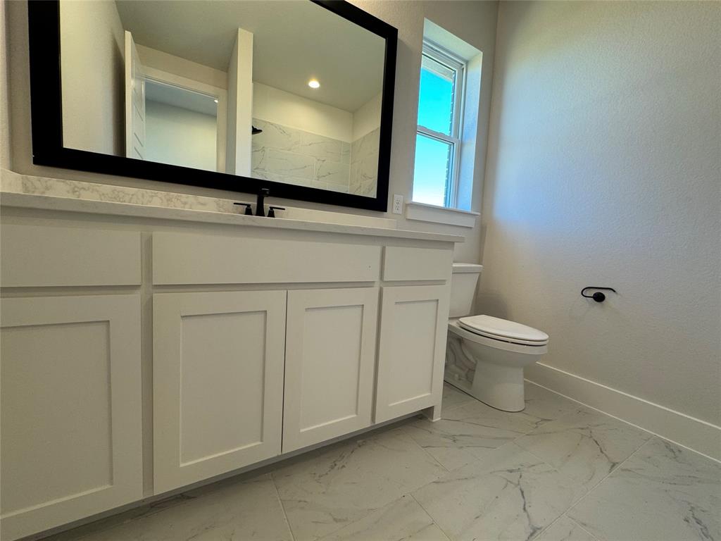 137 Red Fox Trail Godley, TX 76044 - Photo 8 of 18 a bathroom with a sink a toilet and mirror