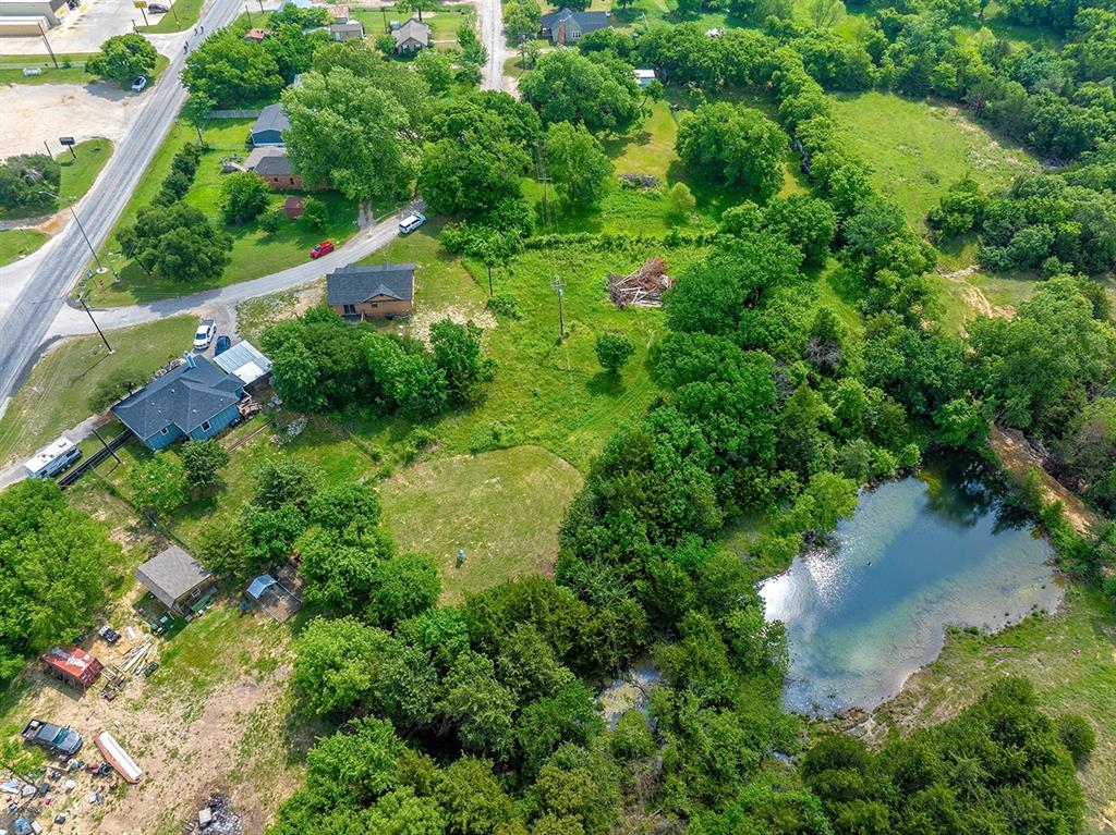371 Spring Street Forestburg, TX 76239 - Photo 30 of 38 an aerial view of residential house with outdoor space and trees all around