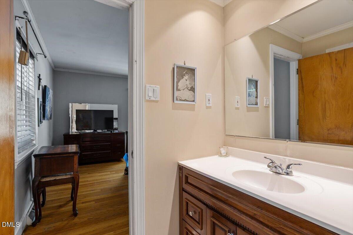 3107 Dixon Road Durham, NC 27707 - Photo 24 of 35 a en suite bathroom with a granite countertop sink and a mirror
