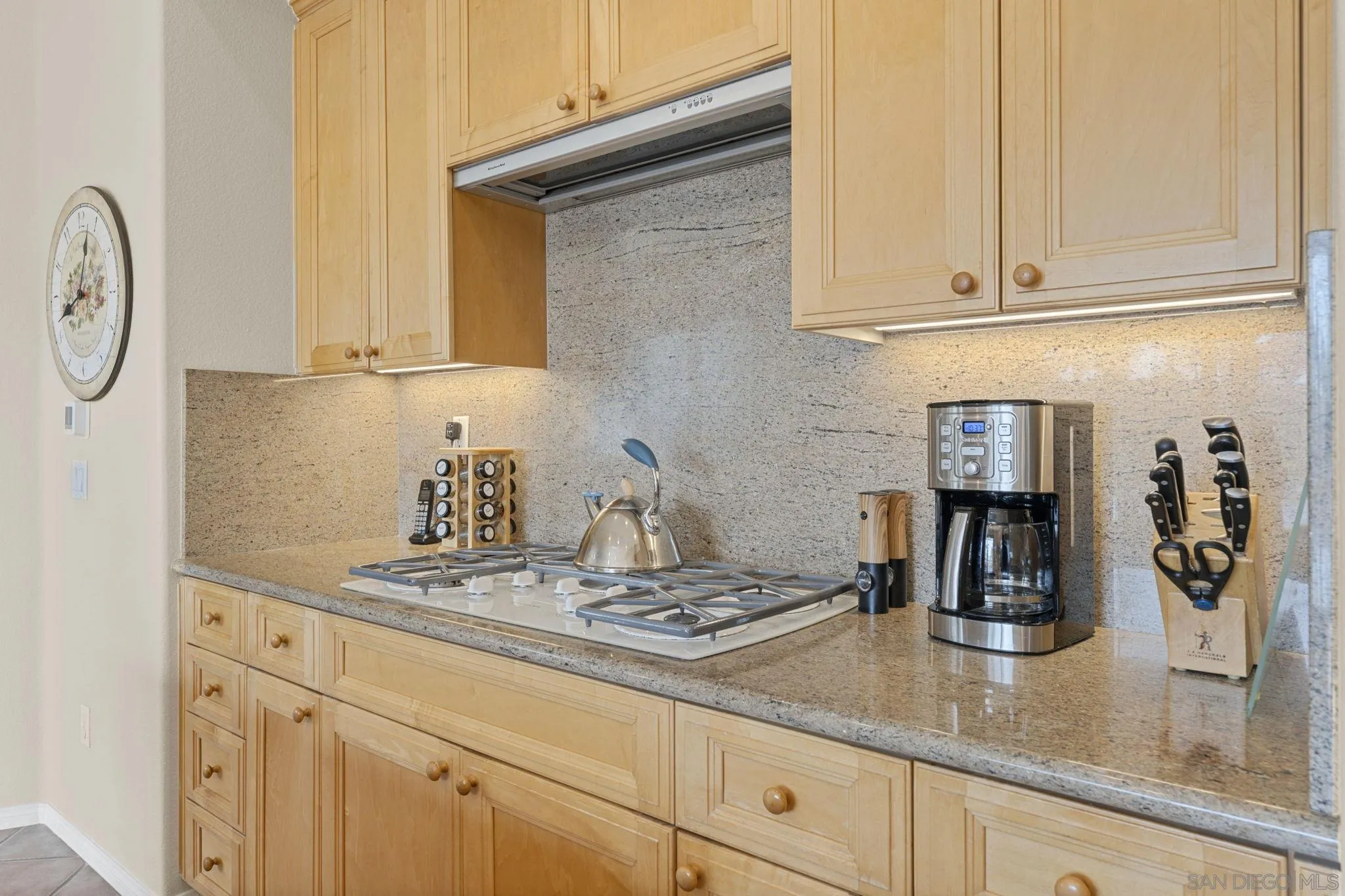 1369 Ranch Road Encinitas, CA 92024 - Photo 11 of 34 a kitchen with granite countertop a sink a stove and cabinets