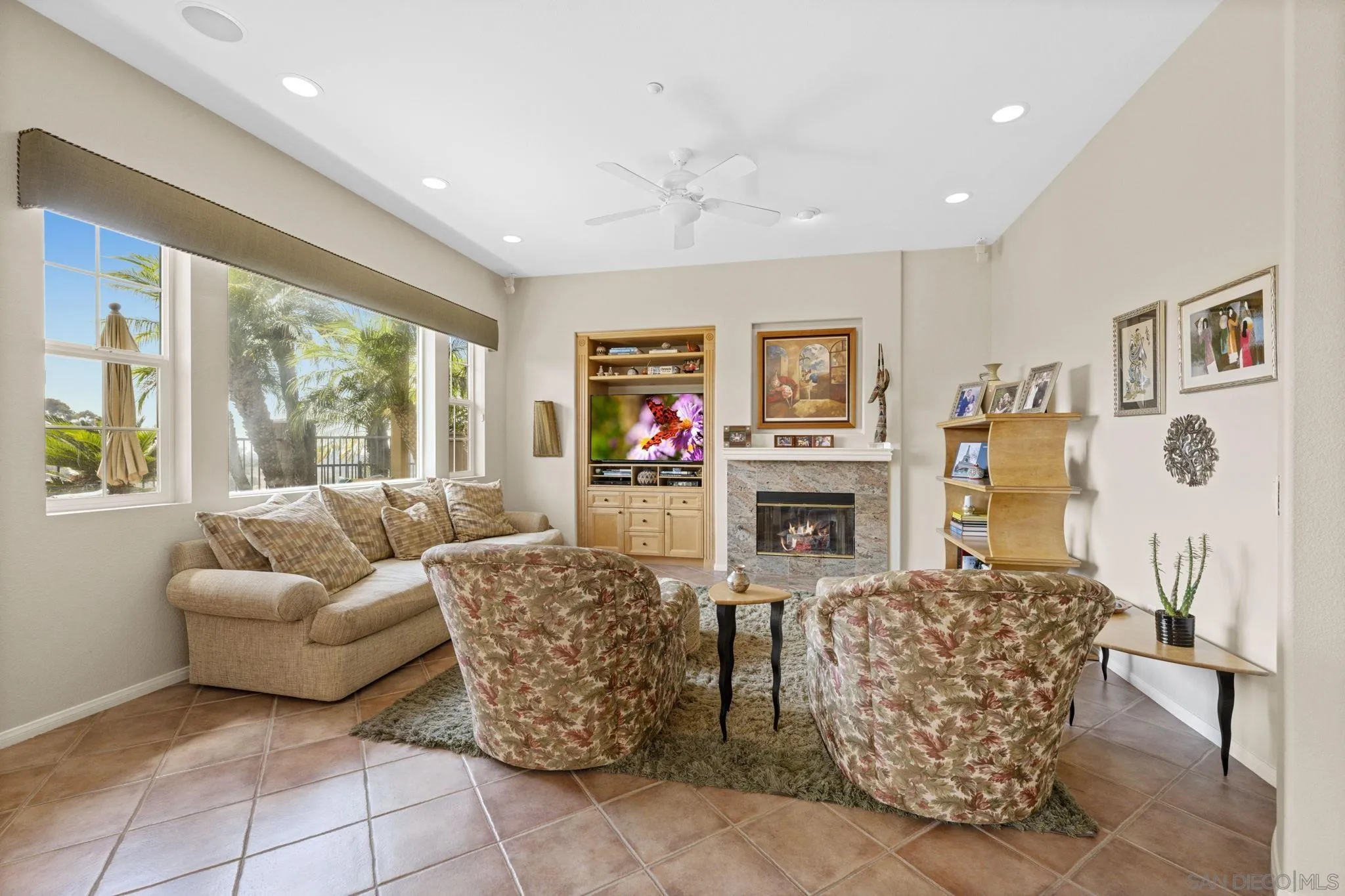 1369 Ranch Road Encinitas, CA 92024 - Photo 14 of 34 a living room with furniture a flat screen tv and a fireplace
