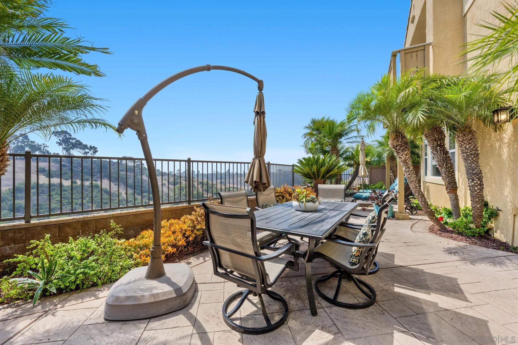 1369 Ranch Road Encinitas, CA 92024 - Photo 28 of 34 a patio with table and chairs with potted plants