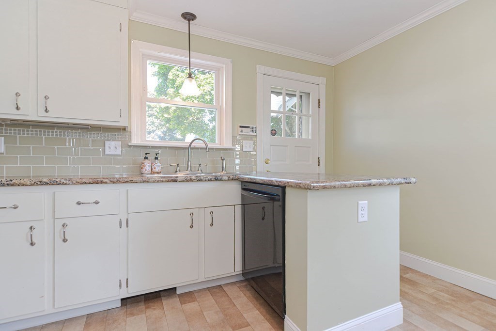 12 Ballard Street Saugus, MA 01906 - Photo 13 of 38 a kitchen with granite countertop white cabinets and a window
