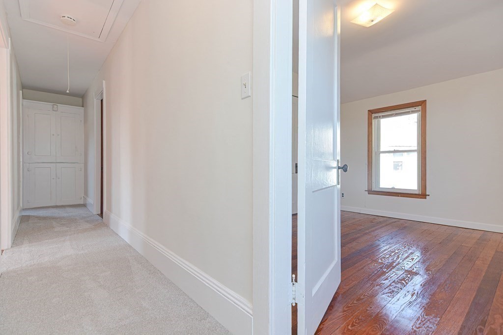 12 Ballard Street Saugus, MA 01906 - Photo 17 of 38 an empty room with wooden floor and windows
