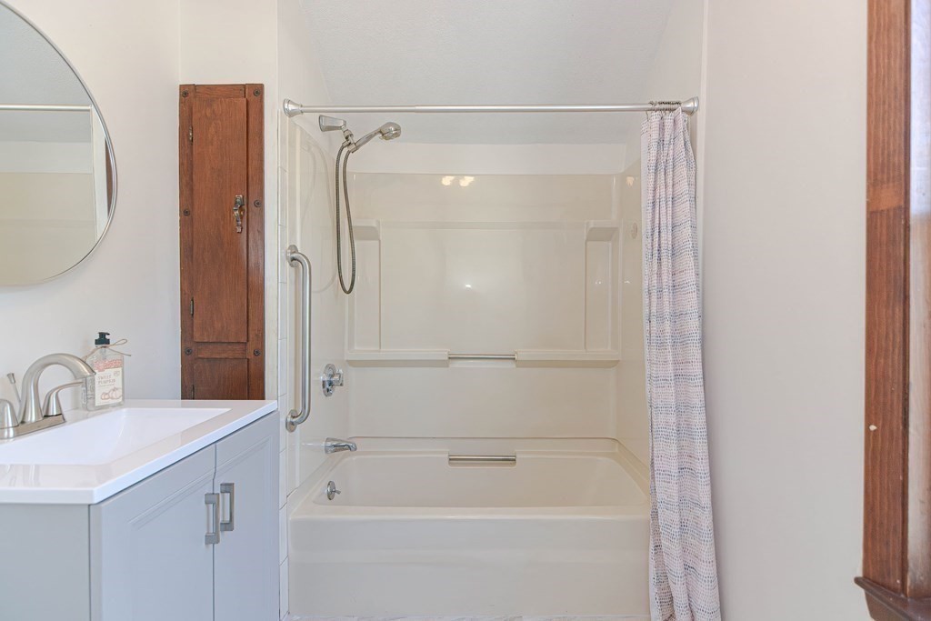 12 Ballard Street Saugus, MA 01906 - Photo 26 of 38 a bathroom with a shower sink and mirror