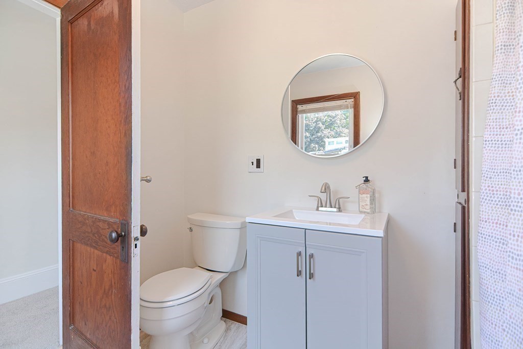 12 Ballard Street Saugus, MA 01906 - Photo 27 of 38 a bathroom with a toilet a sink and a mirror