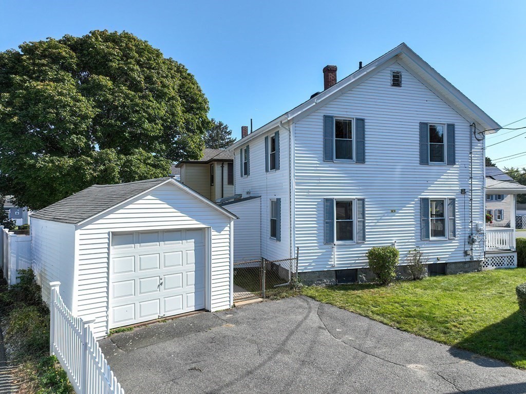 12 Ballard Street Saugus, MA 01906 - Photo 3 of 38 a front view of a house with a yard and garage