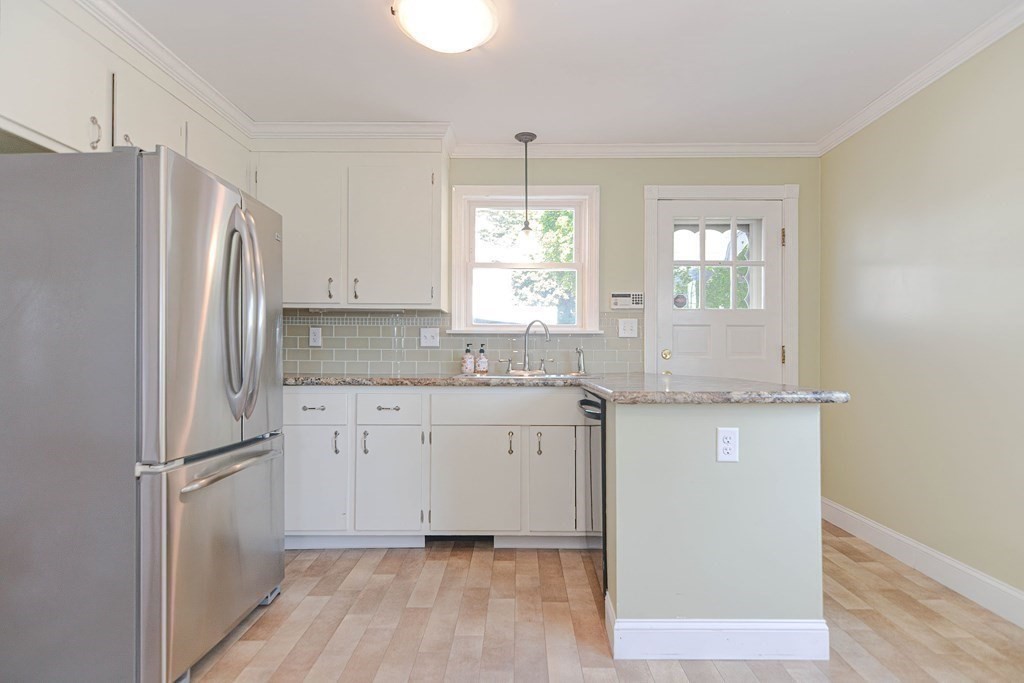 12 Ballard Street Saugus, MA 01906 - Photo 31 of 38 a kitchen with granite countertop a refrigerator sink and cabinets