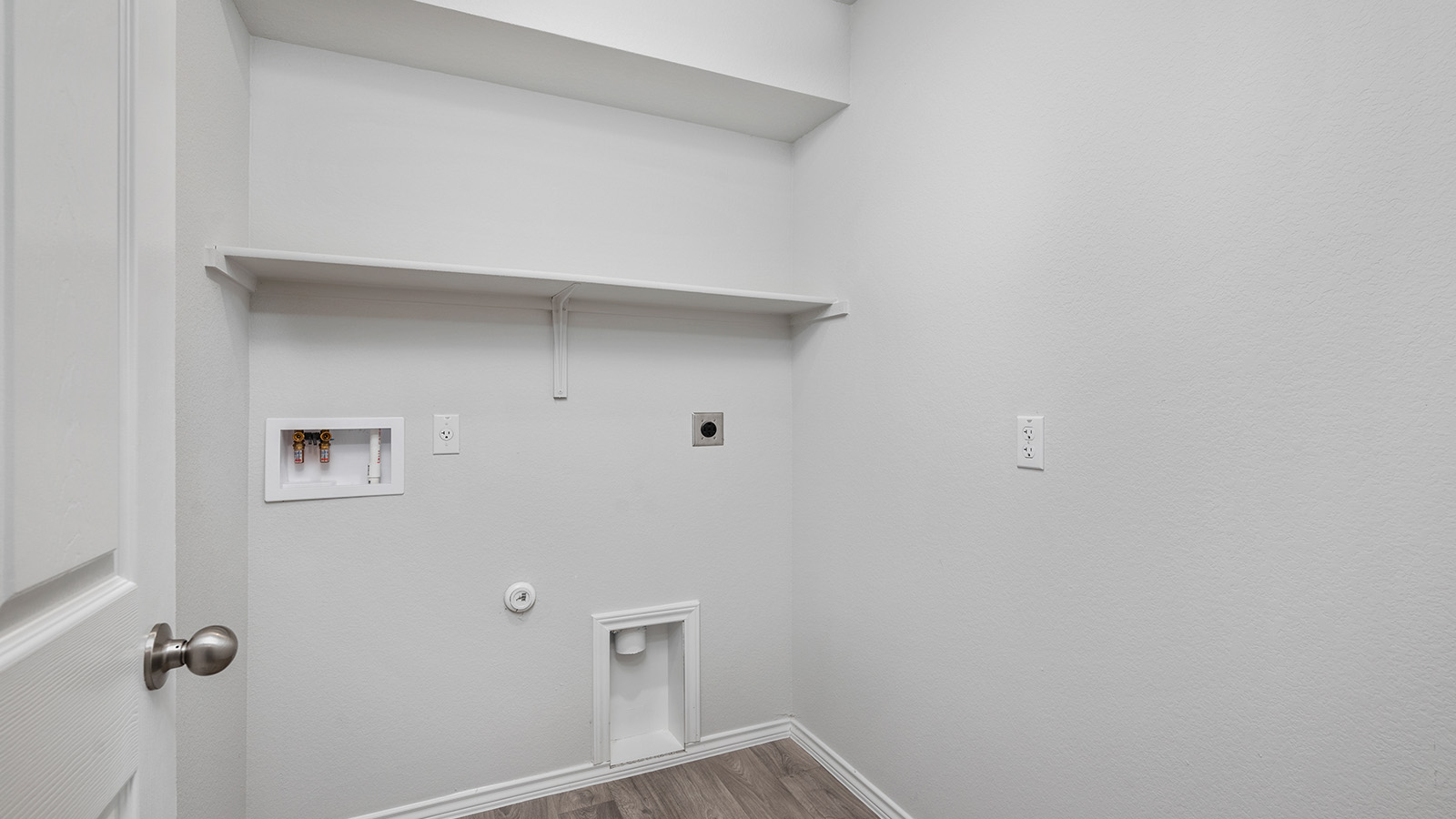 1400 Victory Rnch Trail Killeen, TX 76549 - Photo 21 of 22 Utility space featuring a built-in shelf, plumbing and electrical hookups, and wood-look flooring