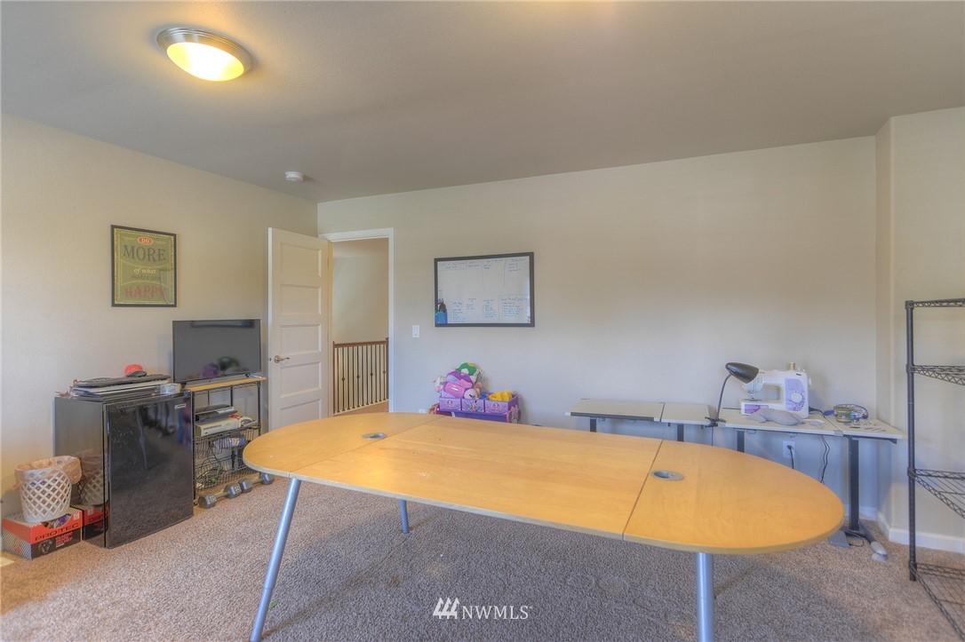 4745 Rosa Court Lacey, WA 98503 - Photo 22 of 25 a room with a table chair and a bed