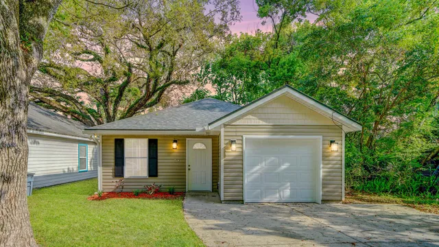 a front view of a house with garden