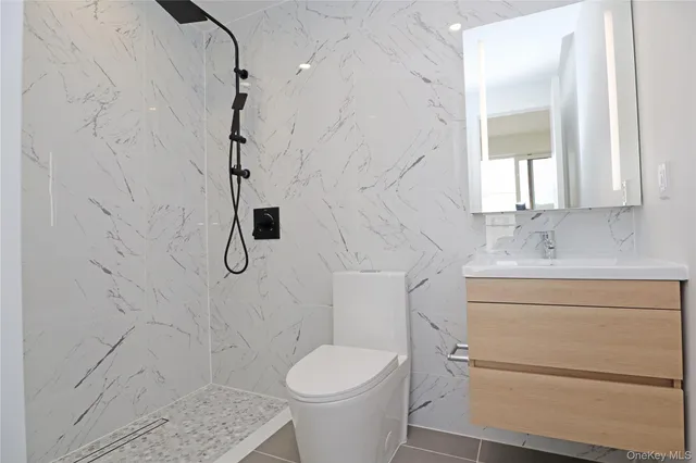 an empty room with closet and a bathroom