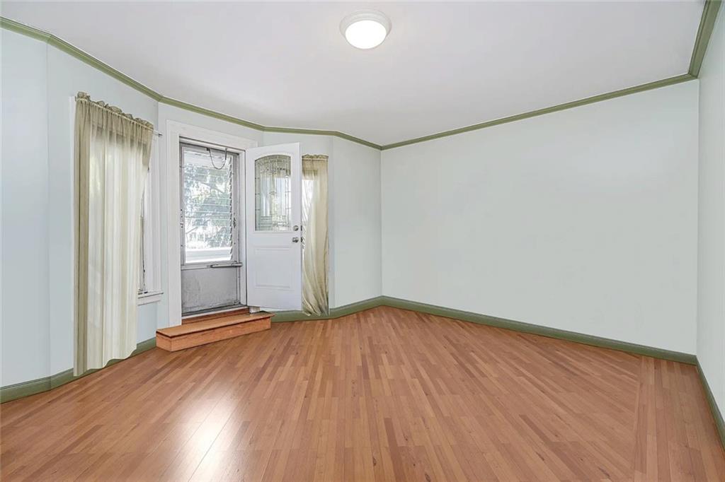 222 Albemarle Road Brooklyn, NY 11218 - Photo 12 of 41 an empty room with wooden floor and windows