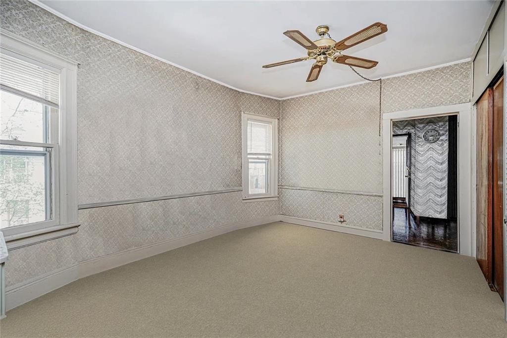 222 Albemarle Road Brooklyn, NY 11218 - Photo 13 of 41 an empty room with windows and fan