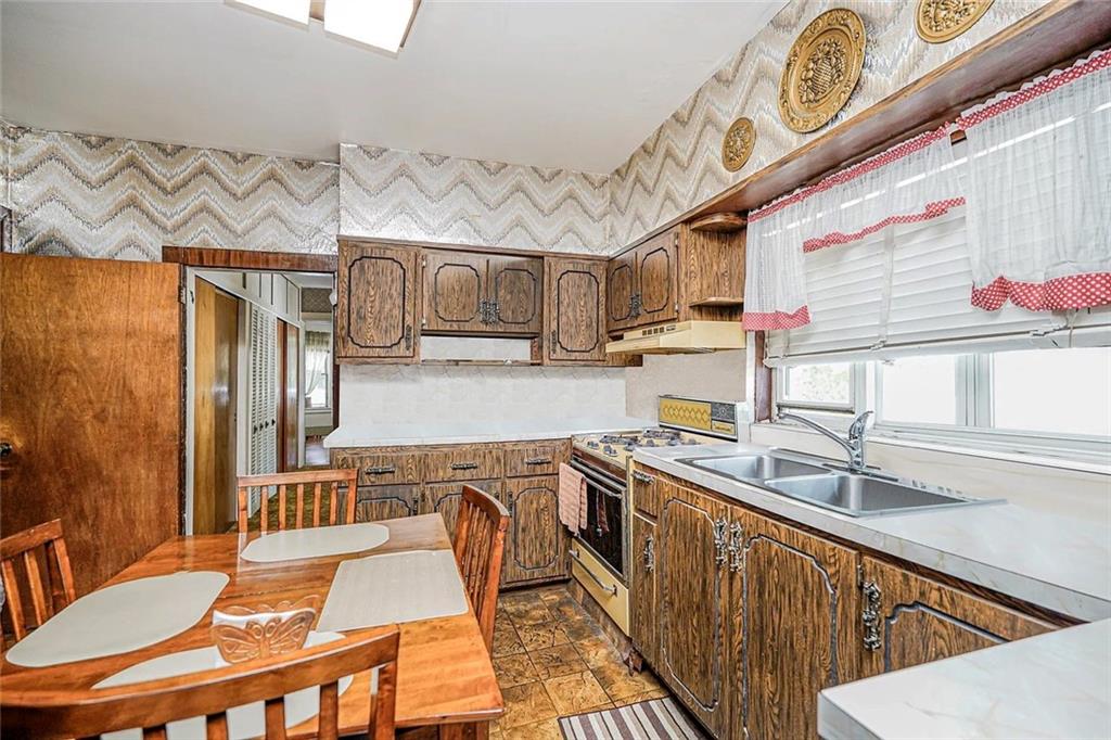 222 Albemarle Road Brooklyn, NY 11218 - Photo 15 of 41 a kitchen with stainless steel appliances granite countertop a sink a stove and a wooden floors