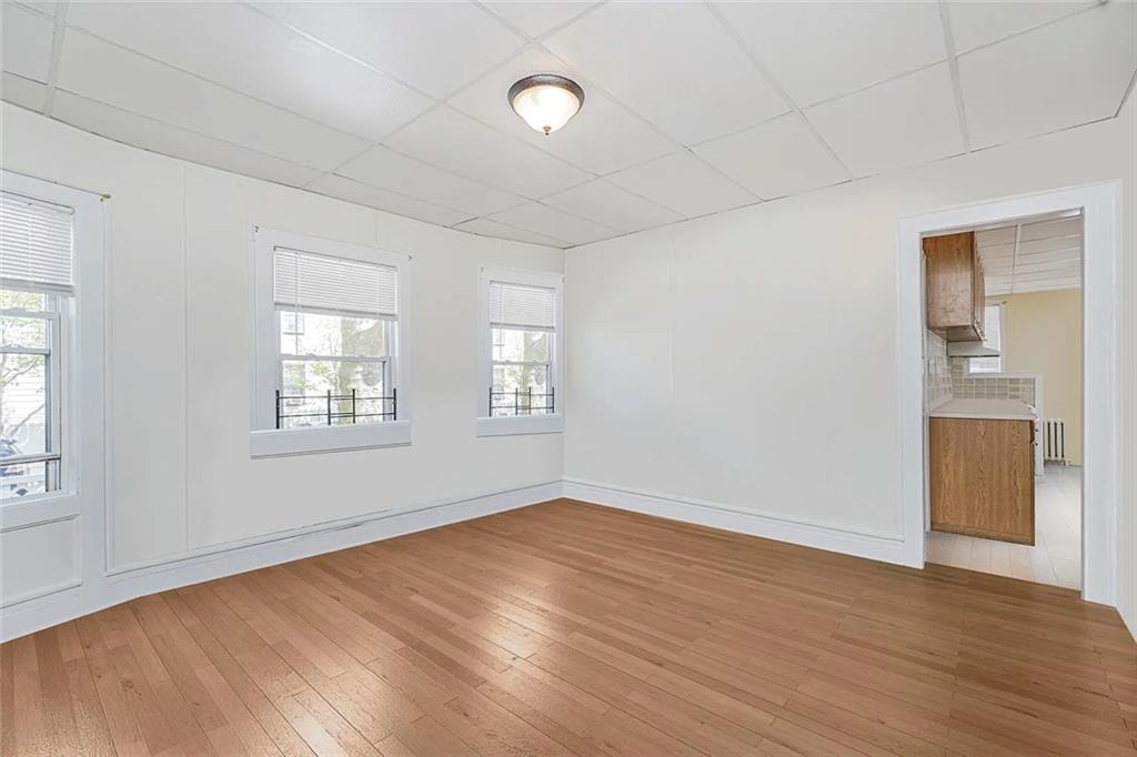 222 Albemarle Road Brooklyn, NY 11218 - Photo 6 of 41 an empty room with wooden floor and windows