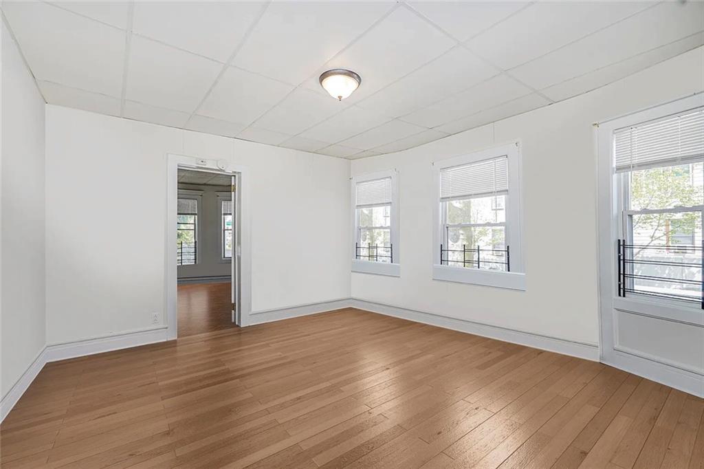 222 Albemarle Road Brooklyn, NY 11218 - Photo 7 of 41 an empty room with wooden floor and windows