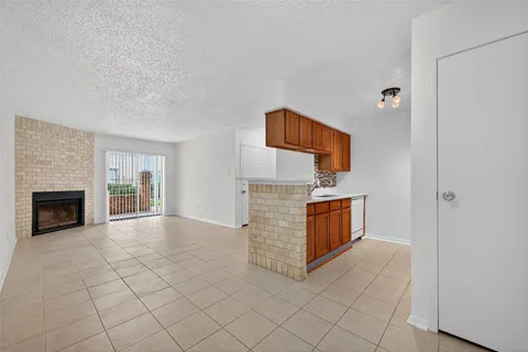 a view of an empty room and fire place