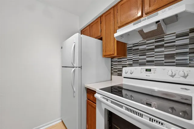 a kitchen with stainless steel appliances a stove and a microwave