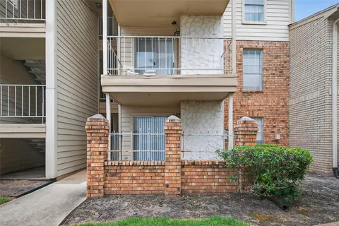 a front view of a house with a yard and potted plants